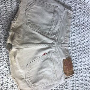 Cream coloured Levi cut offs.
